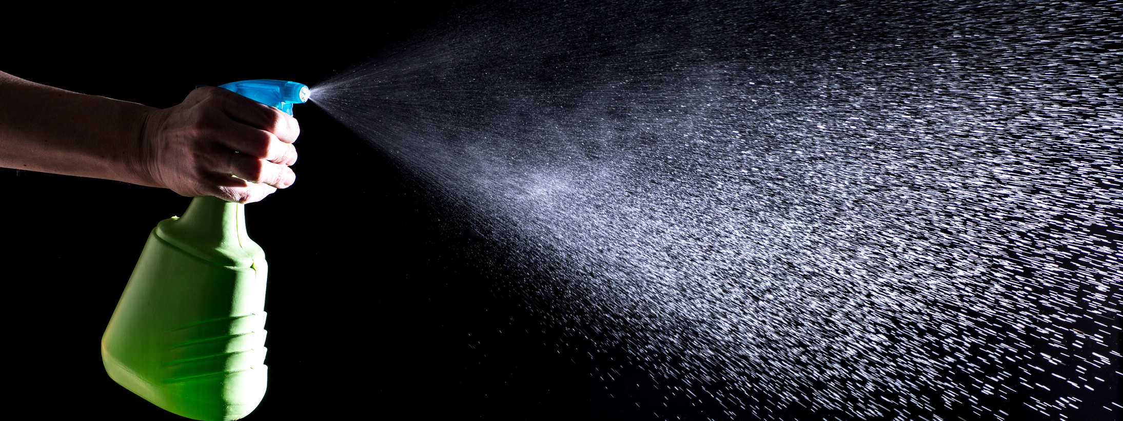 Woman Spraying Liquid Cleaner